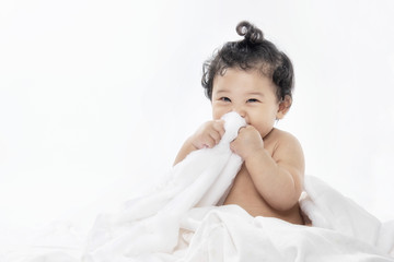adorable baby girl sitting on a bed ,After the bath