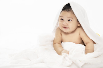 adorable baby girl sitting on a bed ,After the bath