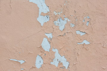 Peeling pink paint on a concrete surface. Background on the theme of apartment repairs