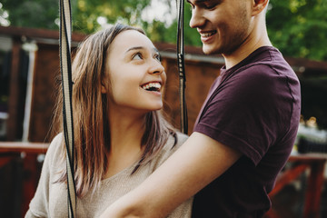 Laughing young couple in harness