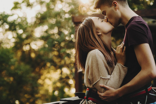 Kissing young couple in summer park - Powered by Adobe