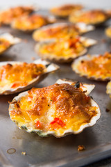 oven baked scallop with cheese, bell pepper and herbs