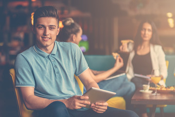 Young male using digital tablet in modern startup office