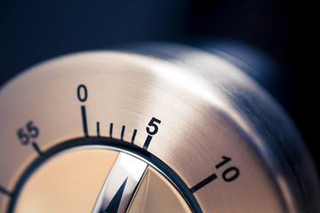 5 Minutes - Close-Up Of An Analog Chrome Kitchen Timer With Dark Background