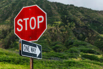 Stop, one way sign with beatiful mountains in the background, Oahu island, Hawaii
