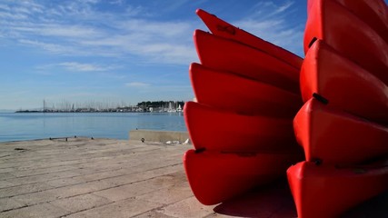 Red kayaks on the coast of Split Croatia - Powered by Adobe