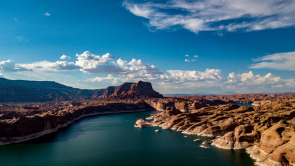 Naklejka premium Aerial view of Lake Powell near Navjo Mountain, San Juan River in Glen Canyon with colorful buttes, skies and water