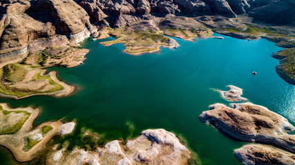 Aerial view of Lake Powell near Navjo Mountain, San Juan River in Glen Canyon with colorful buttes, skies and water