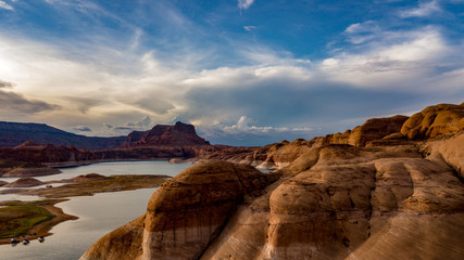 Aerial view of Lake Powell near Navjo Mountain, San Juan River in Glen Canyon with colorful buttes, skies and water
