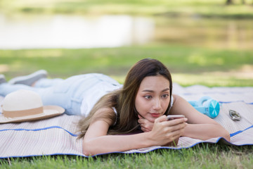 girl play smartphone in summer park