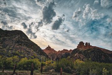 Charyn Grand Canyon with clouds and sun red orange stone Martian landscape