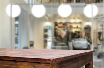 Selected focus empty brown wooden table and Coffee shop or restaurant blur background with bokeh image. for your photomontage or product display