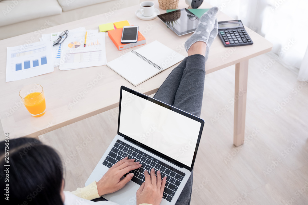 Poster top view of woman use laptop and leg on table chill out working at home.mock up template device screen.Digital lifestyle concept.clipping path screen.