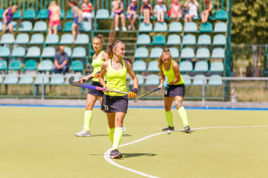 Young field hockey player girl with stick in the game