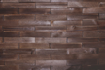 Textural background dark brown wooden bricks