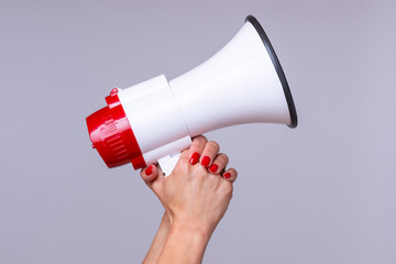 Woman holding up a loud hailer or megaphone