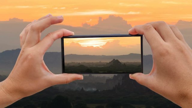 Cinemagraph of Taking Photo of Sunset with Temple Silhouette in Bagan, Myanmar, with Mobile Phone