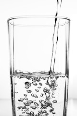 Water pouring into the clear glass