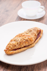 croissant ham cheese on white plate