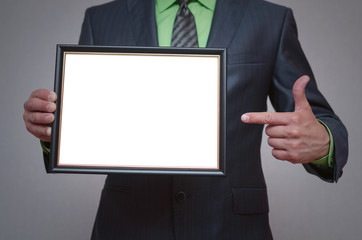 Blank diploma or certificate mock up in businessman hand. Empty photo frame border with copy space.