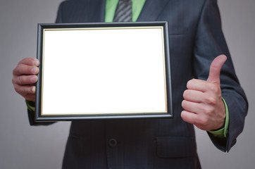 Naklejka premium Blank diploma or certificate mock up in businessman hand. Empty photo frame border with copy space.