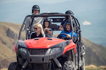 Friends driving off-road with quad bike or ATV and UTV vehicles
