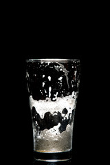 empty craft beer glass on black background