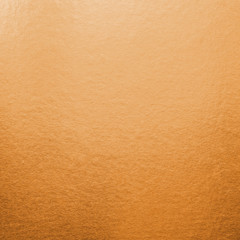 Naklejka premium Copper gold background texture metallic wrapping foil paper shiny orange wallpaper for wall backdrop decoration element