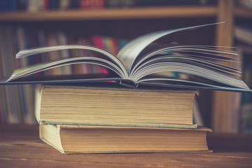 open book on a rustic wooden table.