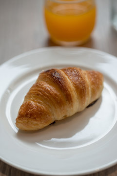 Plain croissant on white plate