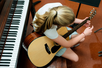 music student practices guitar in practice room