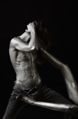 Handsome man and sexy female legs painted in silver.