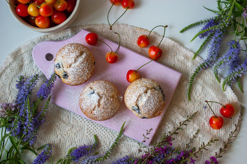 Tasty cupcakes on a white table. Cupcakes with sweet berries.