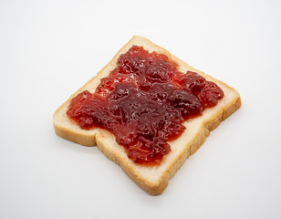 homemade slide bread with strawberry jam isolated on white
