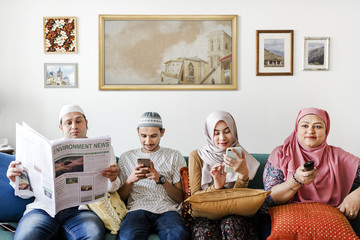 Muslim family reading the news