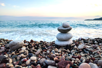 Balanced stones near the beach.  Sunset by the sea.
