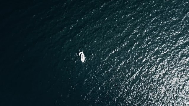 Sailboat on opened sea on aerial view