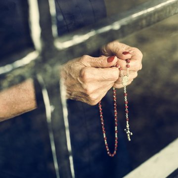 Hands holding cross prayer faith in christianity religion