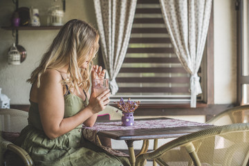 Attractive fashionable plus size young lady at kitchen. Portrait of voluptuous young woman posing sensually on vintage interior background 