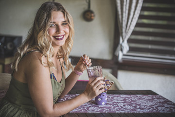 Attractive fashionable plus size young lady at kitchen. Portrait of voluptuous young woman posing...