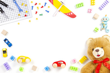 Colorful kids toys frame on white background. Top view. Flat lay.