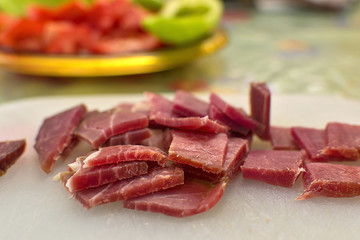 Sliced domestic ham on a kitchen table.