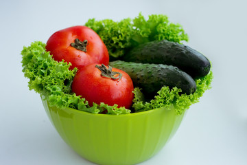 Fresh red tomatoes, green salad and cucumber