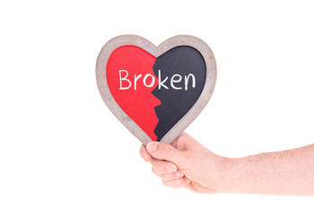 Adult holding heart shaped chalkboard - Broken