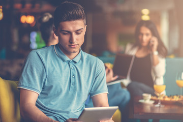 Young male using digital tablet in modern startup office