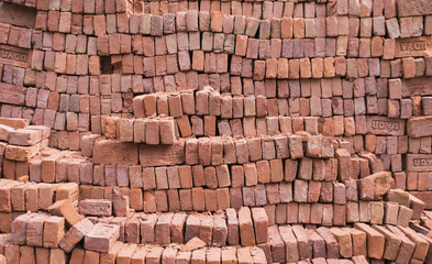 Fototapeta premium construction materials, blocks of an orange brick, all for construction, texture of their bricks, brick color, a background