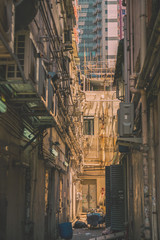 Naklejka premium the narrow street between skyscrapers, what is hidden from eyes technical communications, conditioners and water pipes