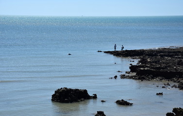East Point Reserve is one of the largest and most popular recreation areas for visitors. Two guys fishing at East Point on the rocks at low tide.