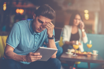Young male using digital tablet in modern startup office