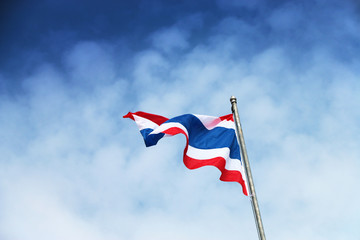 Flag of Kingdom of Thailand (Siam) on blue sky and clouds